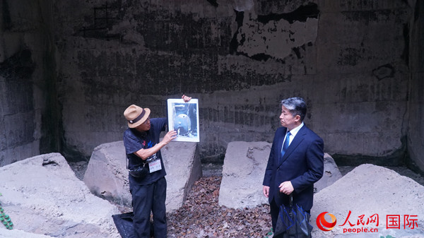 毒氣島歷史研究所事務局長山內正之在毒氣儲存遺址為大家介紹日軍發動毒氣戰的罪證。人民網 蔣曉辰攝