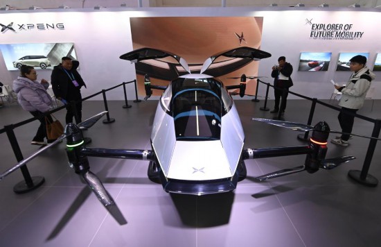2023年12月1日，在鏈博會智能汽車鏈展區小鵬汽車展臺，參觀者觀看一臺智能飛行器。新華社記者蔡湘鑫攝