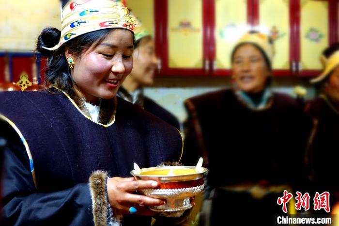 圖為藏族姑娘向客人敬酒。 冉文娟 攝