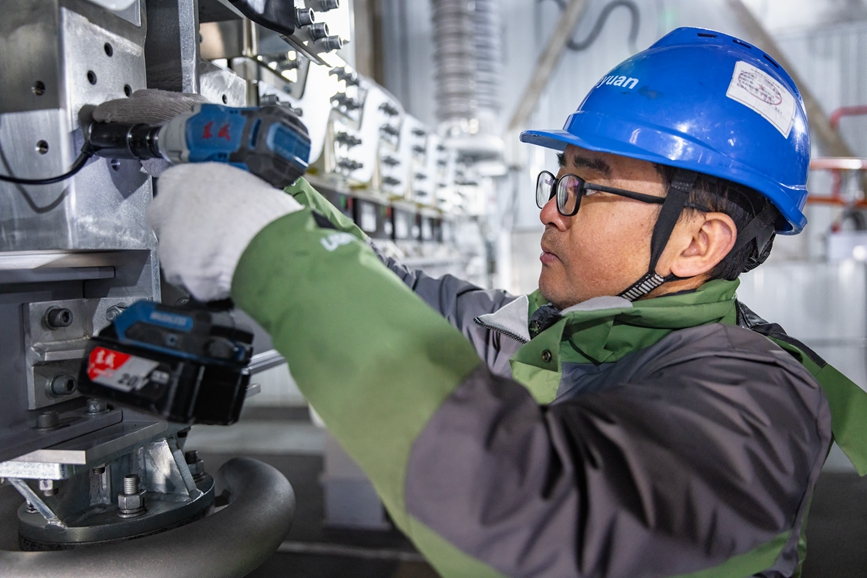 阿里地區首套電網側帶超容構網型SVG工程現場工作人員正在進行投運前螺栓緊固工作。趙清鵬攝